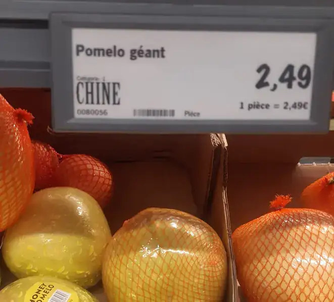 Fruits proposés dans un magasin de Nyons et débat sur leur provenance, les importations et les producteurs locaux des Baronnies.
