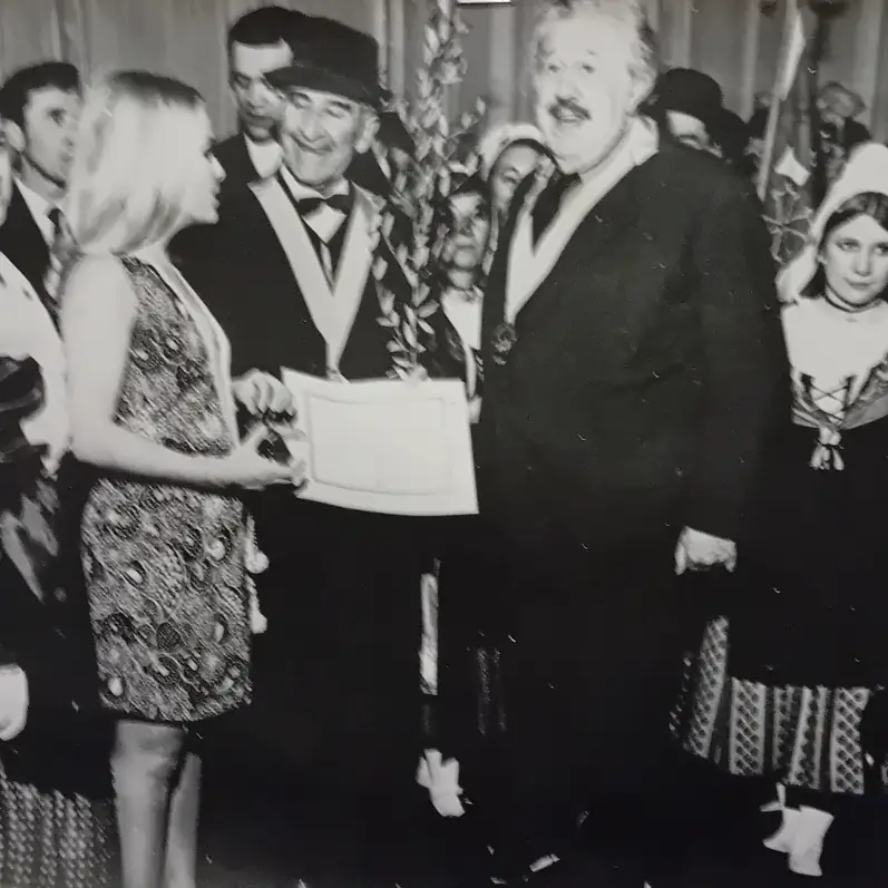 Remise de diplôme à Nyons avec l’acteur Michel Simon, entouré d’élus et de participants en tenue traditionnelle, lors d’une cérémonie officielle dans les années 1960