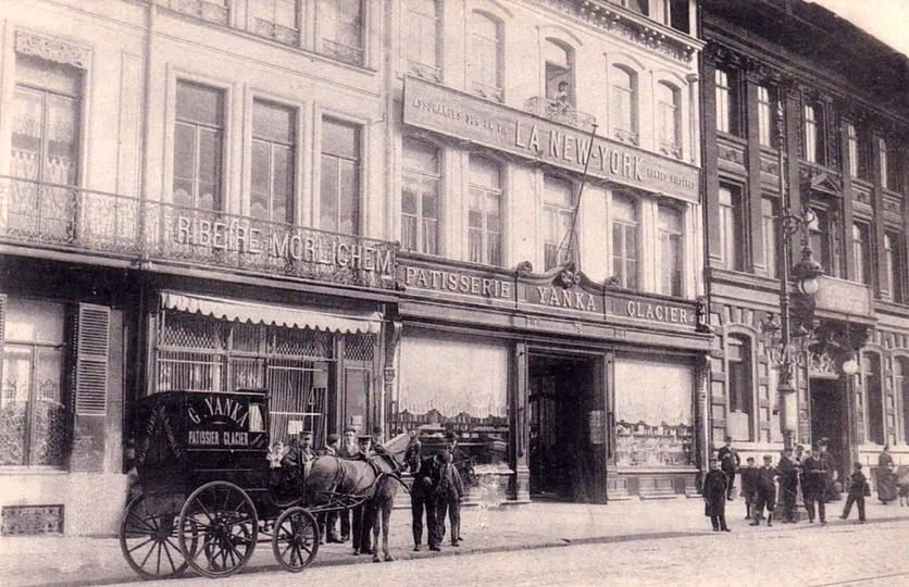 Ancienne pâtisserie Yanka au 75 rue Nationale à Lille, avec sa devanture de glacier, une voiture hippomobile de livraison, des passants et les immeubles voisins.